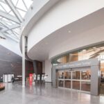 Bright atrium of the Seton Library inside the Brookfield Residential YMCA in Seton, the district next to Mahogany
